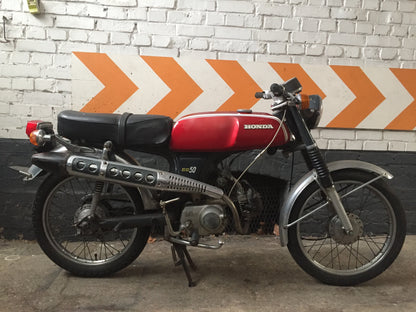 Moto Honda SS 50 cm3 année 1970, vue de côté, avec détails du moteur et du cadre, authentique moto vintage.